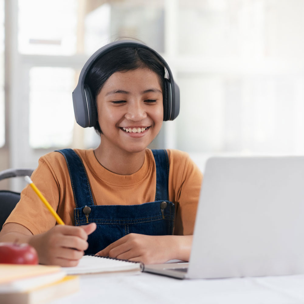 A smiling girl doing online therapy