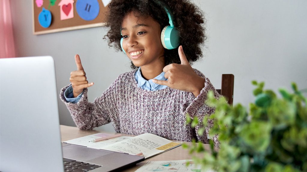 A happy student in a session on her laptop