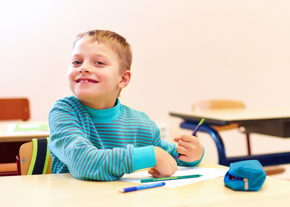 A smiling student in a classroom